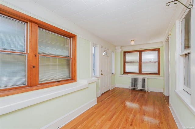 unfurnished sunroom with radiator