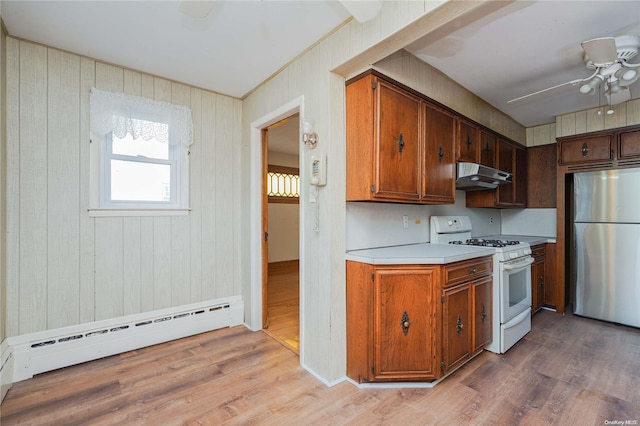 kitchen featuring white gas stove, stainless steel fridge, light wood-type flooring, and a baseboard radiator