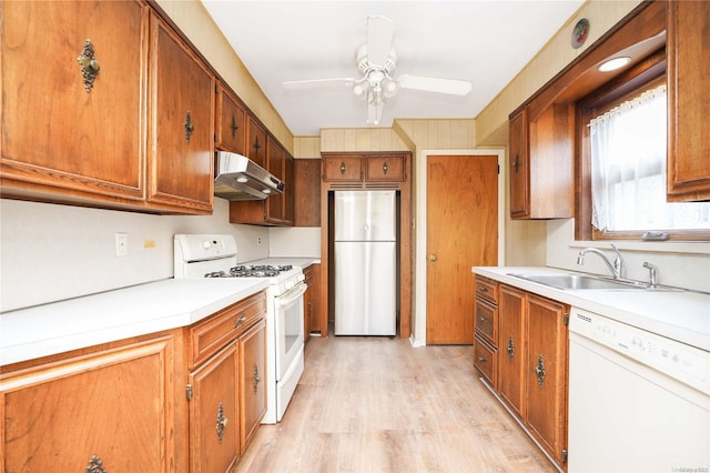 kitchen with white appliances, light hardwood / wood-style floors, ceiling fan, and sink