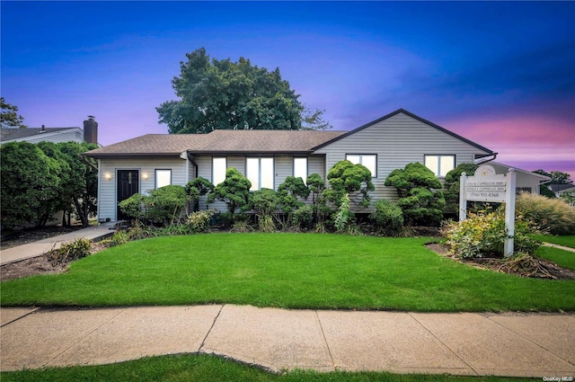 ranch-style house featuring a lawn