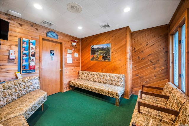 interior space with dark carpet and wooden walls