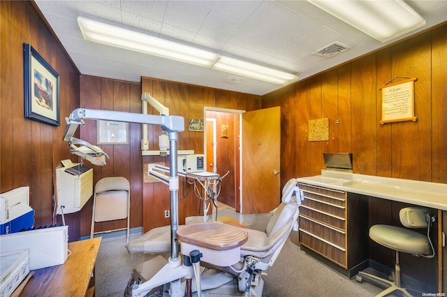 carpeted office with wood walls