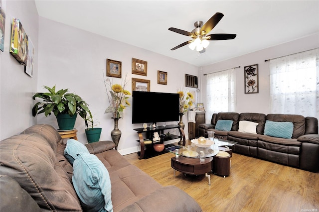 living room with ceiling fan and light hardwood / wood-style floors