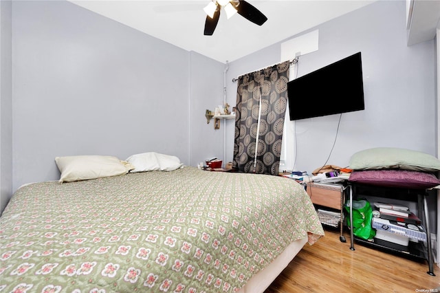 bedroom with hardwood / wood-style flooring and ceiling fan