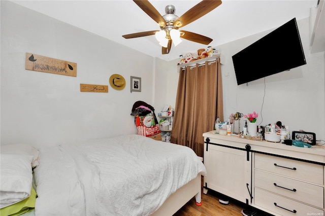 bedroom with hardwood / wood-style flooring and ceiling fan