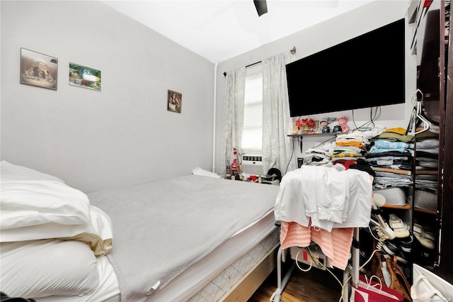 bedroom with ceiling fan and hardwood / wood-style floors