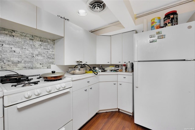 kitchen featuring white appliances, dark hardwood / wood-style floors, and white cabinetry