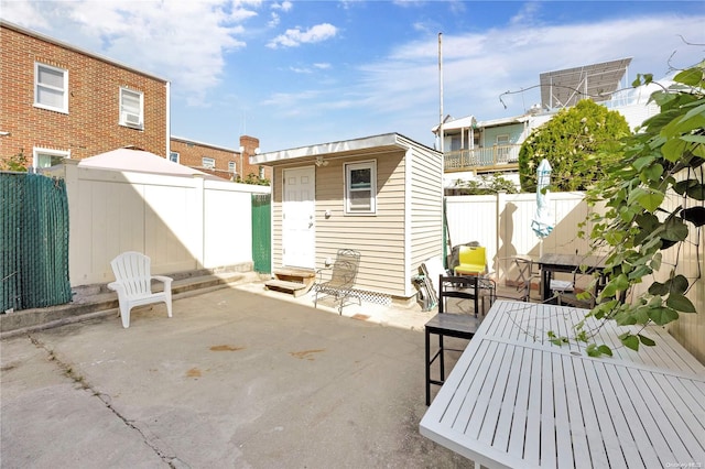 view of patio / terrace featuring a storage unit