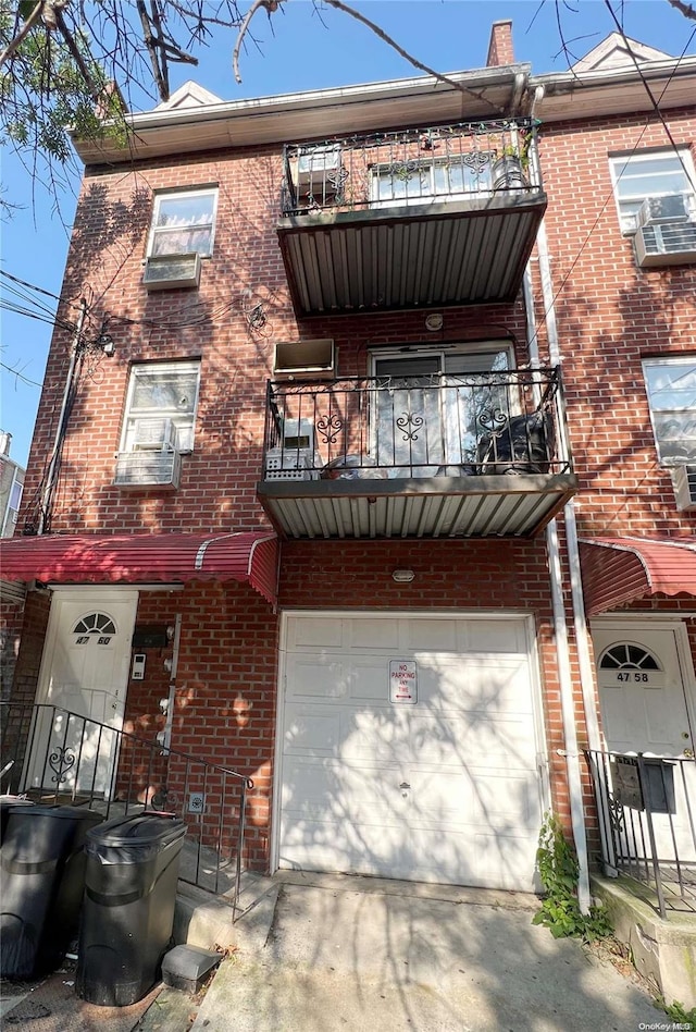 townhome / multi-family property featuring a balcony and a garage