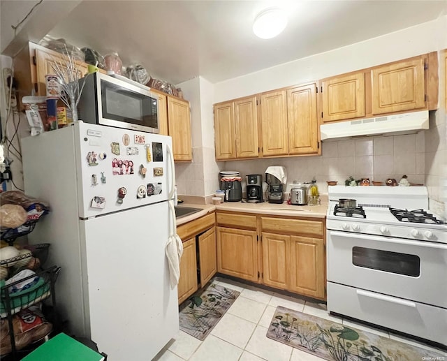 kitchen with light tile patterned floors, white appliances, and tasteful backsplash