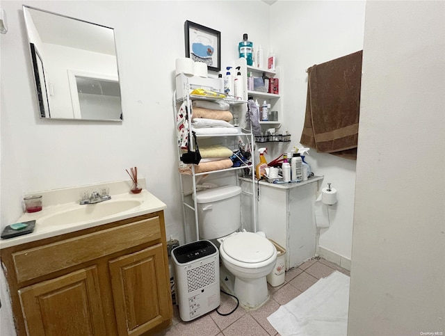 bathroom featuring tile patterned flooring, vanity, and toilet