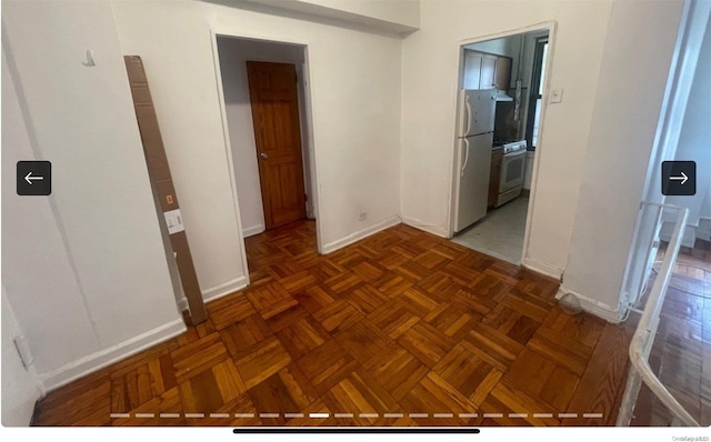 hall with dark parquet flooring