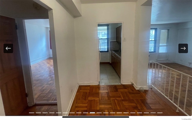 hallway featuring parquet floors