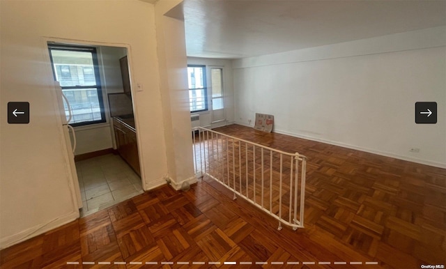 hallway with dark parquet flooring