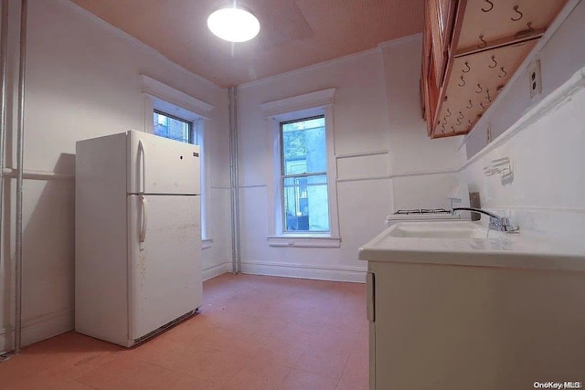 kitchen featuring white fridge and sink