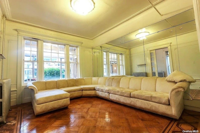 living room featuring parquet floors and crown molding