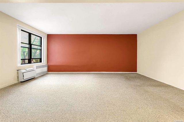 empty room featuring carpet flooring and radiator