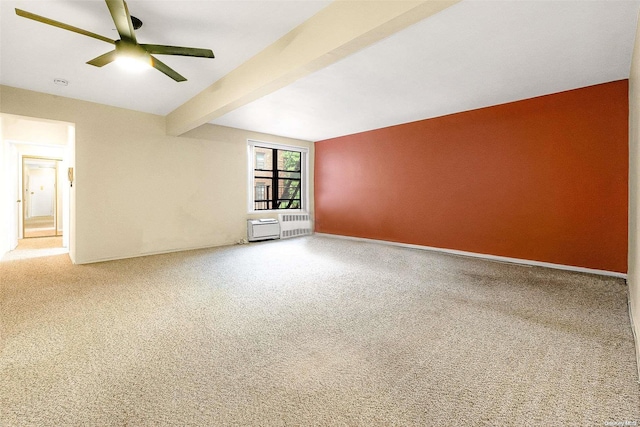 spare room featuring carpet flooring, beam ceiling, and ceiling fan