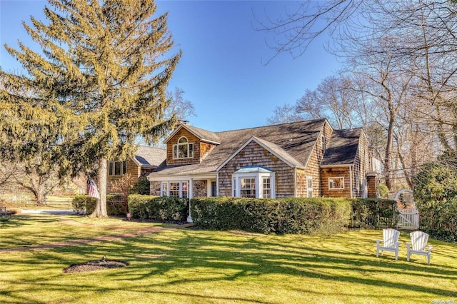 new england style home featuring a front yard