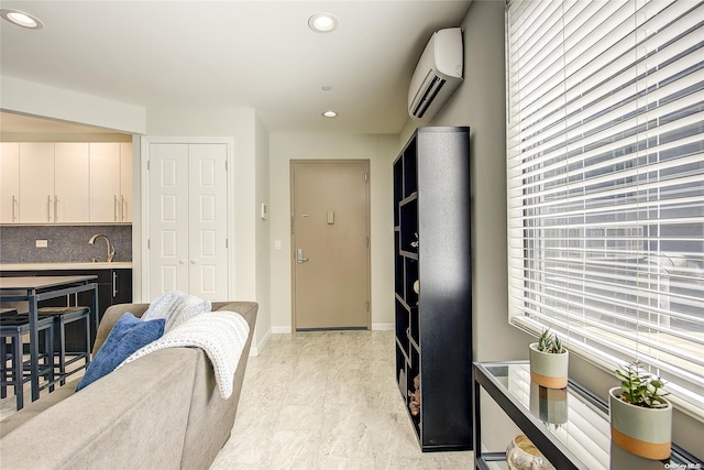 living room with sink and a wall unit AC