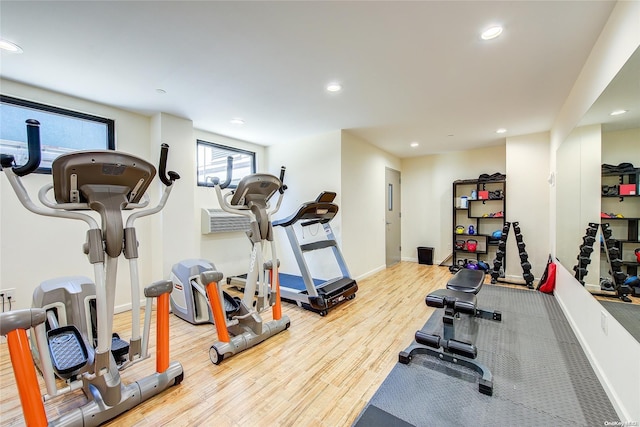 exercise room with hardwood / wood-style floors