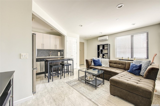 living room featuring a wall mounted air conditioner, baseboards, and recessed lighting