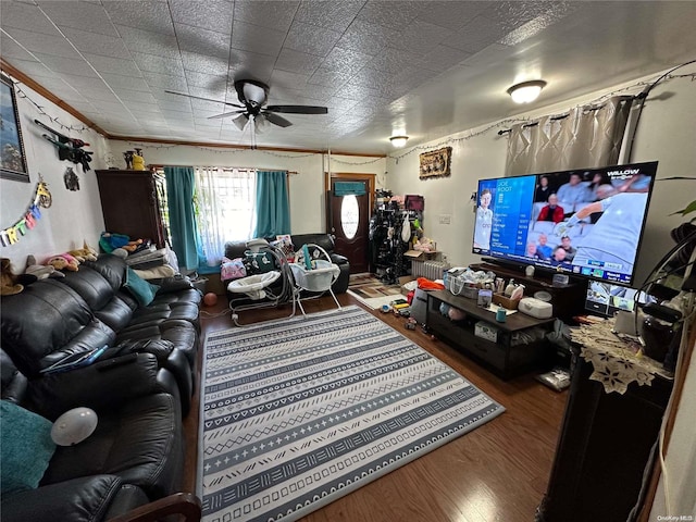 living room featuring hardwood / wood-style floors and ceiling fan