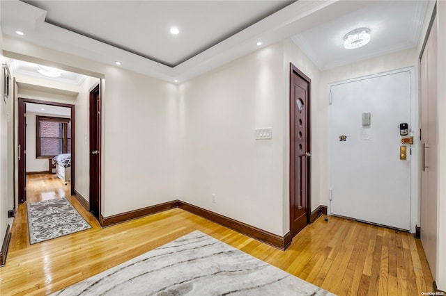 corridor with wood-type flooring and ornamental molding