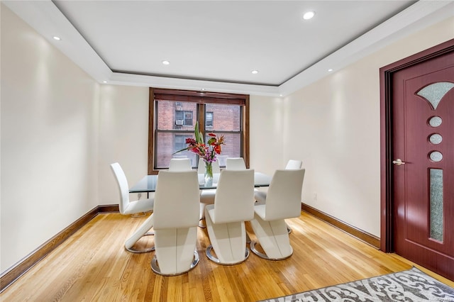 dining space with wood-type flooring