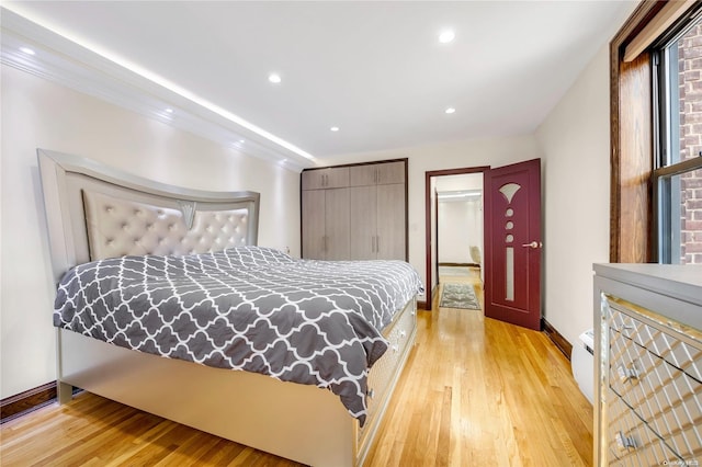 bedroom with light hardwood / wood-style flooring and ornamental molding