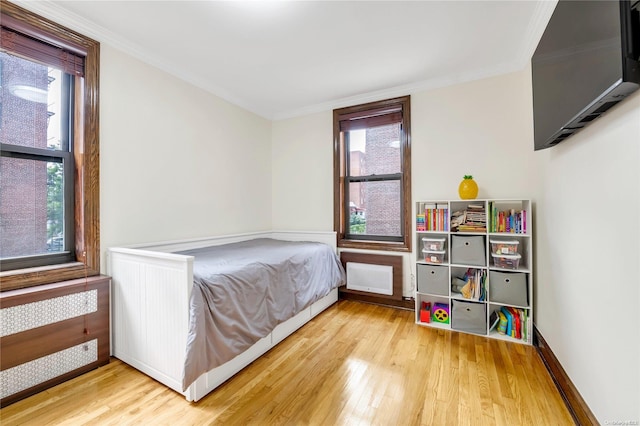 bedroom with wood-type flooring and ornamental molding