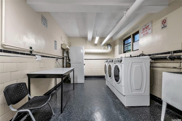 clothes washing area featuring washer and dryer