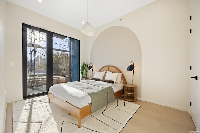 31-16 21st St Unit Ph2C, Astoria, NY 11106 - bedroom with wood finished floors, access to exterior, baseboards, recessed lighting, and arched walkways