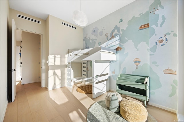 31-16 21st St Unit Ph2C, Astoria, NY 11106 - bedroom featuring wood finished floors, wallpapered walls, and baseboards