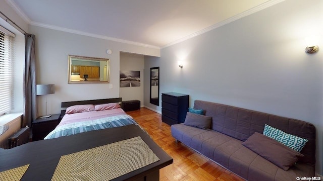 bedroom featuring multiple windows, radiator, and crown molding