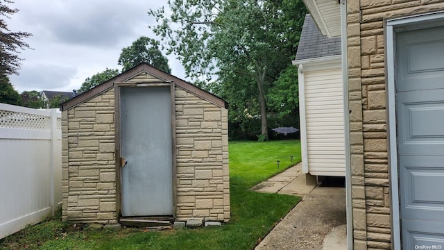 view of outbuilding featuring a lawn