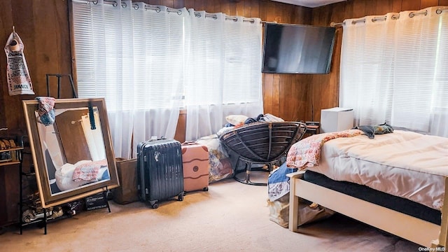 carpeted bedroom with wooden walls