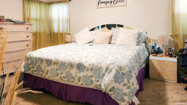 bedroom featuring carpet flooring and multiple windows