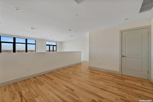 spare room featuring light hardwood / wood-style flooring