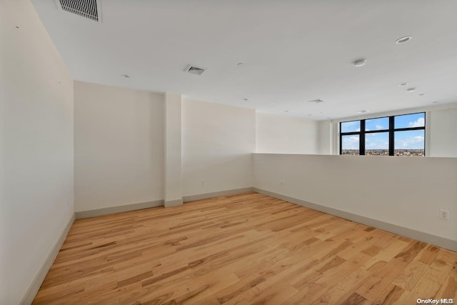 unfurnished room with light wood-type flooring