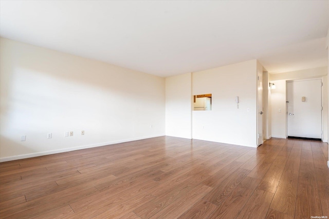 empty room with dark hardwood / wood-style floors