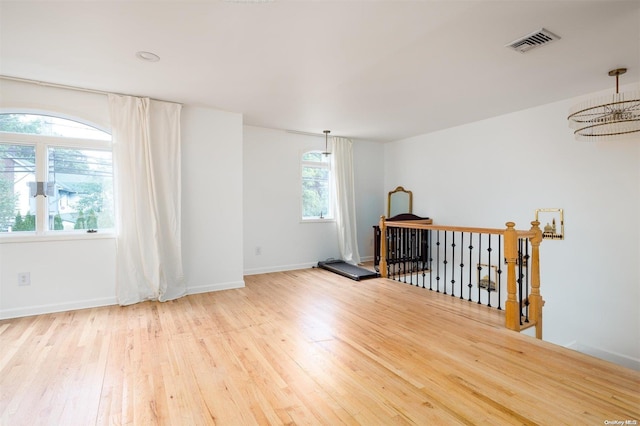 unfurnished room featuring light wood-type flooring and plenty of natural light