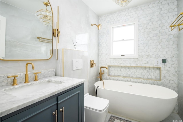 bathroom featuring vanity, toilet, a tub, and a notable chandelier