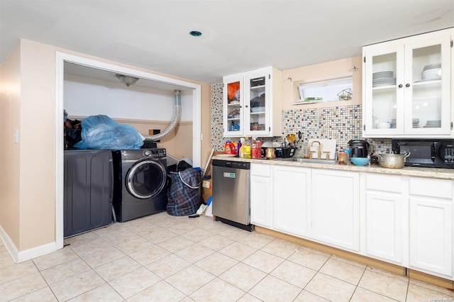 kitchen with white cabinetry, backsplash, dishwasher, light stone countertops, and sink