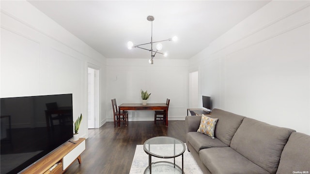 living room with dark hardwood / wood-style floors and a notable chandelier