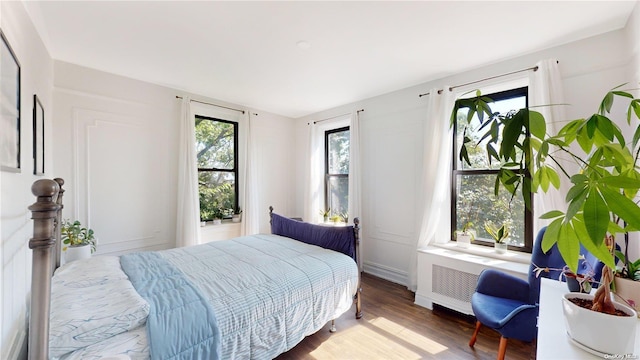 bedroom featuring radiator and wood-type flooring