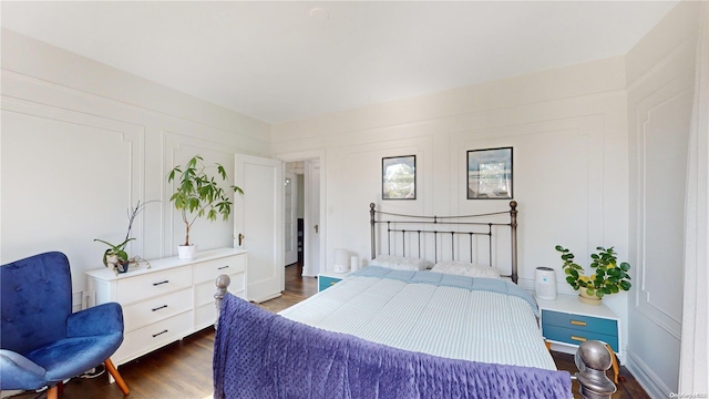 bedroom with dark hardwood / wood-style flooring