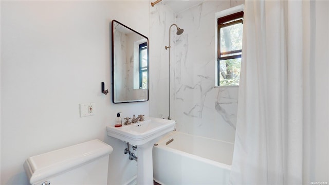 bathroom with shower / bath combo and toilet