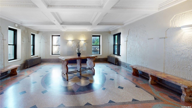 interior space with beamed ceiling, ornamental molding, radiator, and coffered ceiling