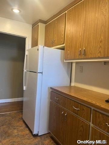 kitchen with white refrigerator and wooden counters